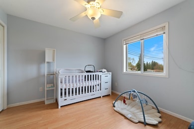 Bedroom featuring light wood-type flooring, basebo