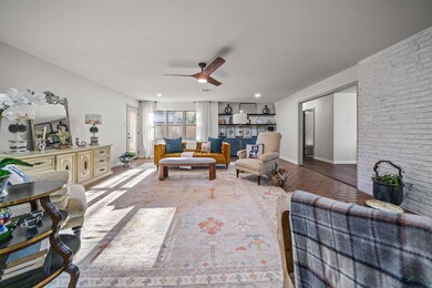 Living room featuring baseboards, brick wall, and 