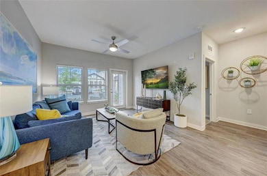 Living room featuring visible vents, light wood-st