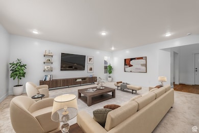 Carpeted living area featuring recessed lighting