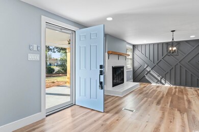 Doorway to outside featuring a fireplace, a notabl
