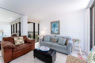 Living area featuring floor to ceiling windows, light tile patterned floors, and ceiling fan