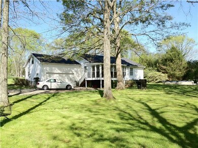 Back of house showing Sun room and 2 car attached garage