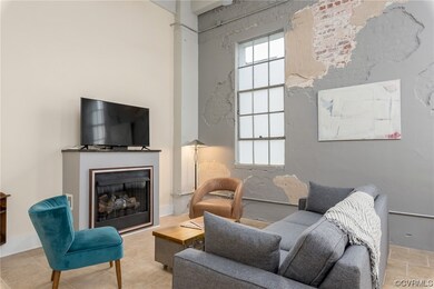Living room with natural light, tile flooring, and TV