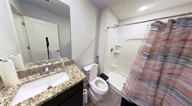 Bathroom featuring toilet, vanity, and hardwood / 