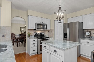 Crisp white cabinets, granite counters, stainless