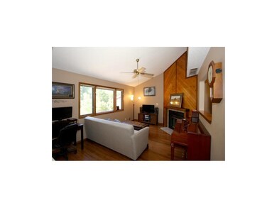 GREAT ROOM HAS SOARING CEILINGS & COZY FIREPLACE F