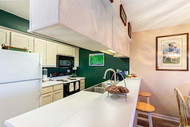 Kitchen featuring sink, white appliances, a textur
