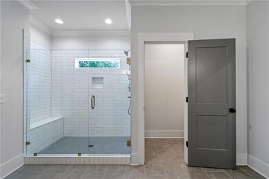 Full bath featuring a shower stall, light tile patterned floors, and recessed lighting
