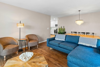 Living room featuring light wood-type flooring, ba