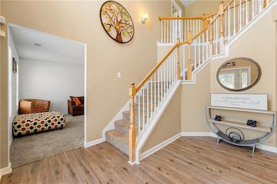 Staircase featuring wood finished floors and baseboards