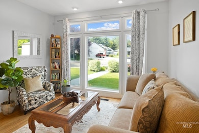 Living area with healthy amount of natural light and wood finished floors