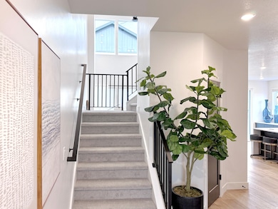 Stairway with wood finished floors and recessed lighting