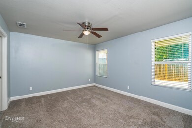 Empty room with carpet and ceiling fan