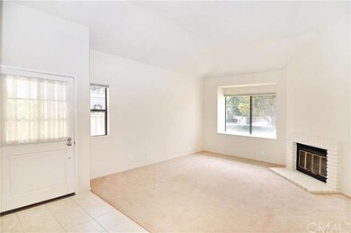 The Living Room has high ceilings and a cozy brick