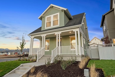 View of front of house featuring roof with shingles, covered porch, and a front lawn