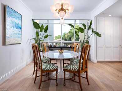 Dining room with a chandelier, light wood-type flooring, and crown molding