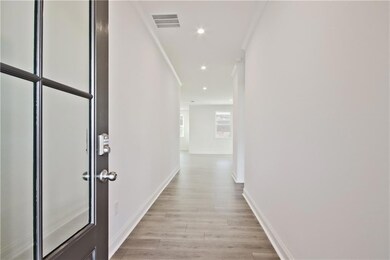 Hall featuring baseboards, recessed lighting, visi