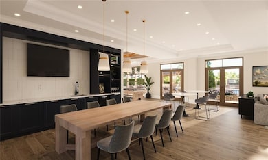 Dining area featuring a tray ceiling, hardwood / w