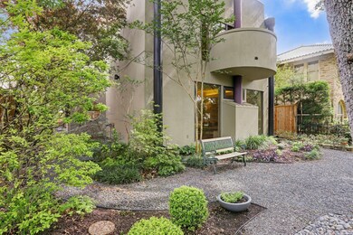 The landscaped front yard with iron fencing become