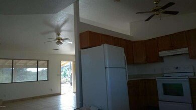 Kitchen looking into living room bright+