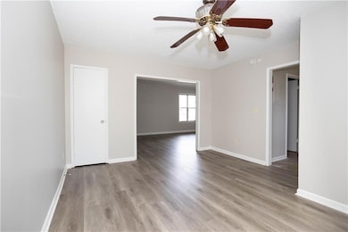 Unfurnished room with ceiling fan, baseboards, and