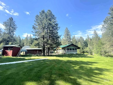 View of grassy yard featuring an outdoor structure