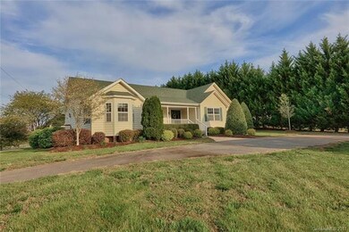 NICE CIRCULAR DRIVEWAY LEADS YOU AND YOUR GUESTS TO THE LOVELY ROCKING CHAIR FRONT PORCH.