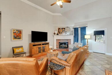 Tiled living room featuring crown molding, ceiling