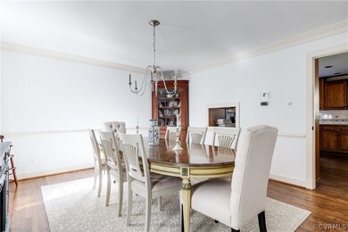 Spacious dining room with chandelier, crown mouldi