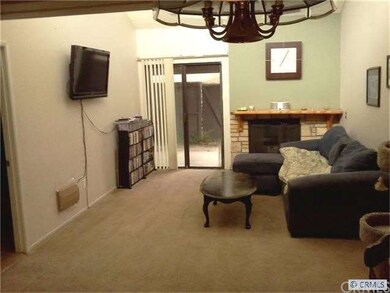 SPACIOUS LIVING ROOM HAS VAULTED CEILNGS, AND FIREPLACE