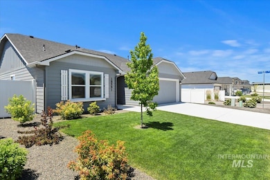 View of front facade featuring an attached garage, driveway, roof with shingles, and board and batten siding