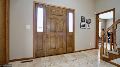 Sunny foyer with high ceiling and attractive custo