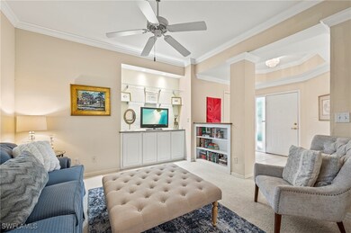 Living room with light carpet, ceiling fan, and cr