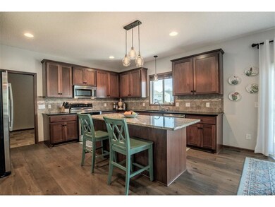 Kitchen features granite countertops with decorati
