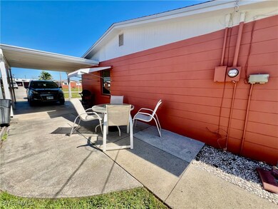 View of patio with a carport, driveway, and outdoo