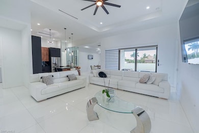 Living room featuring ceiling fan, recessed lighting, and light tile patterned floors