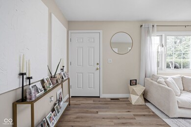 entryway with wood finished floors, baseboards, and visible vents