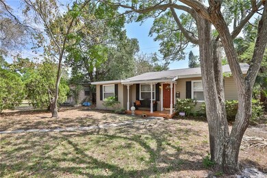 Charming covered front porch with a bright red door!!
