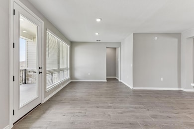 Unfurnished room with light wood finished floors and recessed lighting