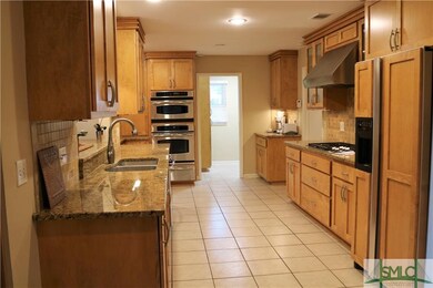 Large remodeled custom kitchen has abundant cabine