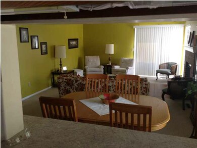 Living room area open to kitchen area.