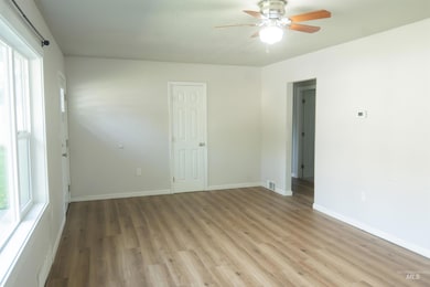 Unfurnished bedroom featuring wood finished floors and ceiling fan