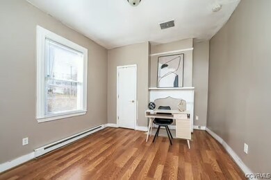 Unfurnished office featuring wood finished floors,