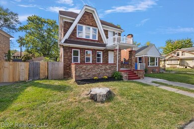 View of front of property with a balcony and brick siding