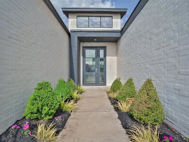 Doorway to property with stucco siding and french doors