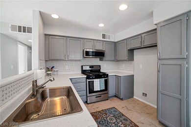 REMODELED KITCHEN WITH STAINLESS APPLIANCES AND BA