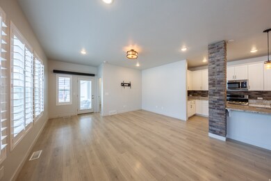 Family room adjacent to kitchen with corner nook area for table.