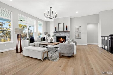 Great Room featuring light wood-style flooring, a stone fireplace, a chandelier, and recessed lighting