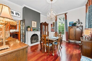To the right from the entry hall is the large formal dining room, one of the original four rooms of the home. The marble fireplace has a new marble hearth (2019) and was re-lined in 2005. Brazilian cherry floors were installed in the early 2000s. The